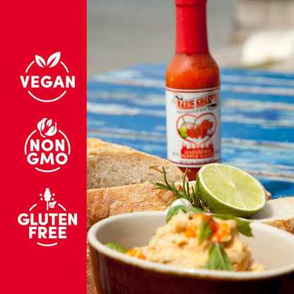 Marie Sharp's Hot Habanero Sauce neben Brot, Dip und Limette, mit Hinweisen vegan und glutenfrei